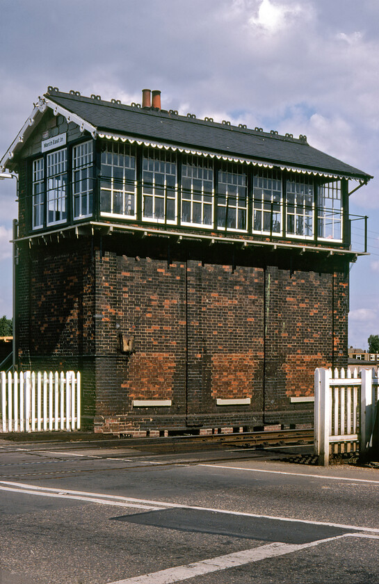 March East Junction signal box (GE, 1885) 
 Catching some welcome sunshine March East Junction signal box stands adjacent to the busy level crossing that it controls where the B1101 Station Road crosses the line. The box is still in operation (at the time of writing in 2023) and is a fine example of a Great Eastern Type 5 design built in 1885 with its ornate decorative edging to the facias and barge boarding. It was raised to its present height in 1897 to give the signalmen a better view of operations with a huge increase in freight activity having taken place. The locking room windows were bricked up during the run-up to World War II to provide better blast protection. The box is now Grade II listed so its immediate future is secure once the resignalling of this route takes place in the not-too-distant future. 
 Keywords: March East Junction signal box Great Eastern