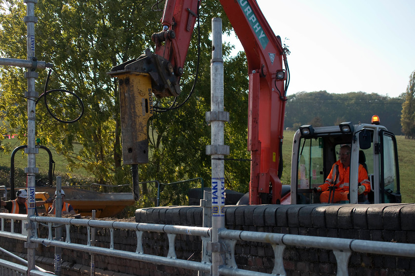 Demolition of Back Lane Bridge, Souldrop Back Lane temporary bridge 
 The hydraulic breaker was having to do very little work demolishing the bridge ramp walls at Back Lane in Souldrop. The mortar was doing nothing with the Victorian bricks being simply pulled off in a cloud of dust. The wall was at quite an alarming angle hence the need to to demolish and rebuild with work scheduled to be completed by February 2019. 
 Keywords: Demolition of Back Lane Bridge Souldrop Back Lane temporary bridge