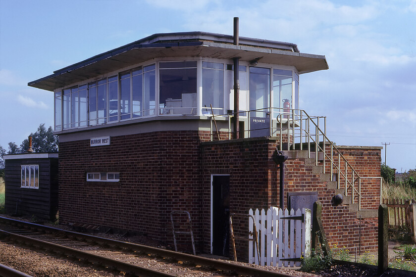 Murrow West signal box (BR, 1950) 
 The tiny Fenland village of Murrow bizarrely once had two stations named East and West serving its meagre population. The two lines, the GN & GE Joint and the M & GN Joint, crossed each other on a flat crossing just to the west of the village. All was well until a disastrous crash between two freight trains the winter of 1941 caused by some frozen points. In this view the GN & GE Joint line passes in front of the superb 1950 British Railways built LNER designed box. Where I am standing M & GN route crossing from left to right at the far end of the box just beyond the small hut. The signalman would have had excellent all-round vision from the box of everything that it controlled. Today the box has been converted into a home, see. https://www.ontheupfast.com/p/21936chg/30044473938/former-murrow-west-signal-box-lner 
 Keywords: Murrow West signal box LNER