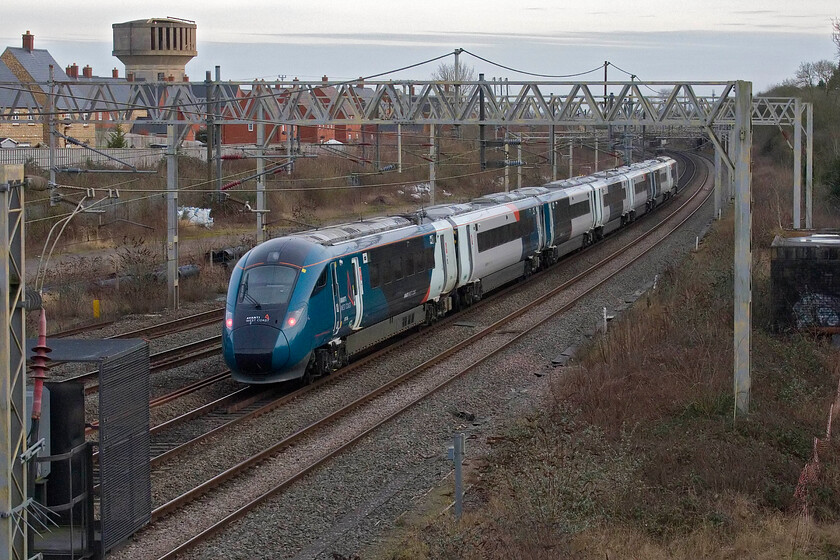 807006, 13.43 Liverpool Lime Street-London Euston (1A54, 1E), site of Roade station 
 A 'going away' shot of 807006 as it passes Roade working the 13.43 Liverpool to Euston service. It is only just over two hours since I took the last photograph but as can be seen, a veil of high cloud has come in and blocked out the brilliant blue sky from earlier. 
 Keywords: 807006 13.43 Liverpool Lime Street-London Euston 1A54 site of Roade station AWC Aavnto Evero