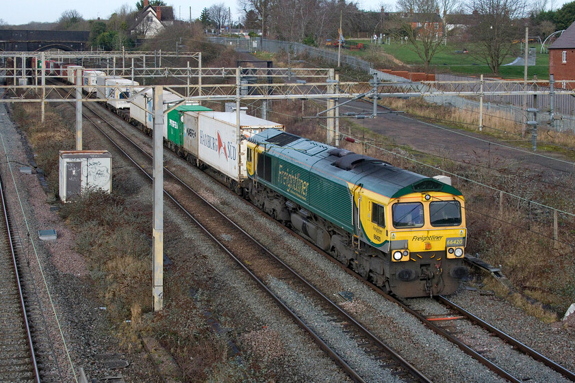 66420, 09.52 Lawley Street-Felixstowe North (4L99, 7L), site of Roade station 
 The 4L99 09.52 Lawley Street to Felixstowe Freightliner passes through Roade at the site of the village's former station worked by 66420. On this occasion, the train was well-loaded with plenty of boxes behind and a smartly presented locomotive up front. 
 Keywords: 66420 09.52 Lawley Street-Felixstowe North 4L99 site of Roade station Freightliner