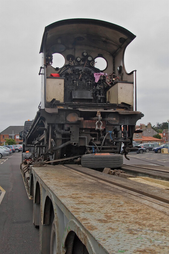 7564, awaiting transportation to Ian Riley & Sons of Bury, Sheringham station car park 
 The cab of 7564 is seen minus its tender (loaded on another low-loader) ready to leave North Norfolk for overhaul. It will make the two-hundred-mile journey to Bury where Ian Riley and Sons will undertake the specialist work of dismantling and rebuilding the locomotive from the ground up. By the next morning, the two low-loaders had left Sheringham so I presume that they made the most of quiet roads by travelling through the night. 
 Keywords: 7564 Ian Riley & Sons of Bury Sheringham station car park