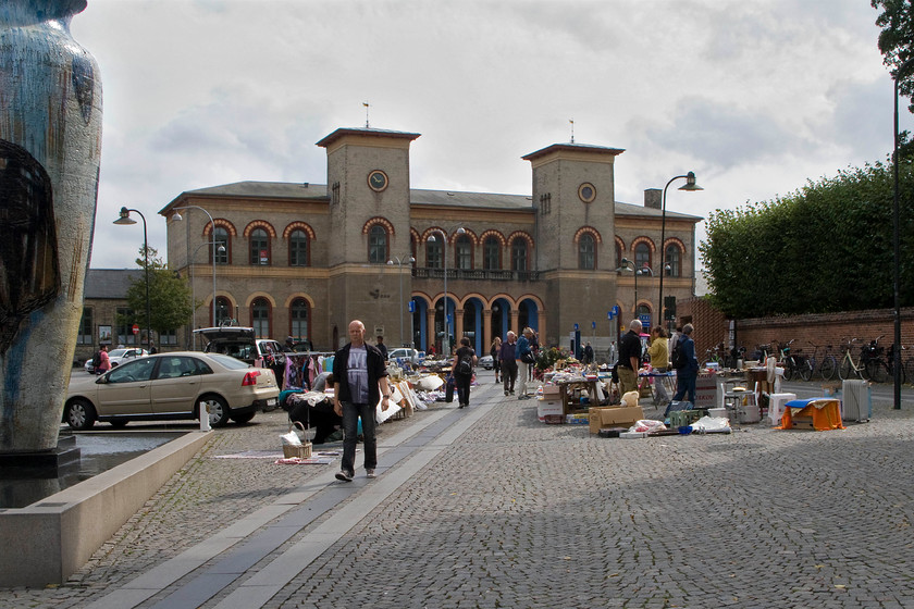 Frontage, Roskilde station 
 The delightful frontage of Roskilde station is a very distinctive design. It is alleged that the Danish architect J.F. Meyer allegedly inspired by Villa Borghese in Rome. It is Danmark's oldest railway station completed and opened in 1874 and being listed in 1964. Notice the flee market taking place on the pavement leading to the station. 
 Keywords: Frontage Roskilde station