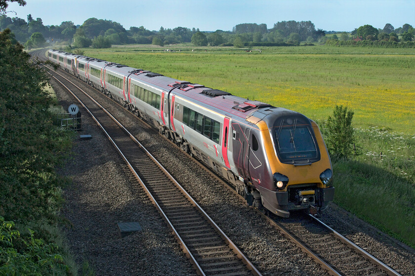 221135 & 220119, XC 06.17 Southampton-Manchester Piccadilly (1M22, 21L), King's Sutton 
 A classic and timeless scene just north of King's Sutton in Northamptonshire - but only just! To the right of the photograph across the meadow is the River Cherwell along which follows the county boundary with Oxfordshire. In fact, this stretch of line that runs from Souldern for about six miles to a spot just north of where I am standing is the only point that the original GWR constructed its own railway in the county of Northamptonshire. 221135 and 220119 pass this bucolic scene with the 1M22 06.17 Southampton to Manchester service. 
 Keywords: 221135 220119 06.17 Southampton-Manchester Piccadilly 1M22, 21L King's Sutton CrossCountry Trains Voyager