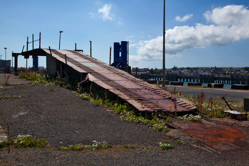 Former car loading ramp, Stranraer Pier 
 The rusting hulk of the former car loading ramp on Stranraer Pier. There was once a Motorail terminal at Stranraer and this was where the cars were driven on and off the carriers. Indeed, I have a picture taken in 1984 of a double deck car carrier in the siding full of vehicles. 
 Keywords: Stranraer Pier