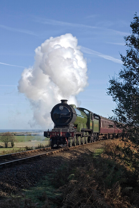 8572, 10.30 Sheringham-Holt, Kelling Bank TG107418 
 Looking resplendent in the morning autumnal sunshine gainst a brilliant blue sky LNER B12 8572 storms up Kelling bank wolrking the NNR's 10.30 Sheringham to Holt service. I must admit to being a trifle linesiding here but I did don my orange hi-viz tabard and was a good distance from the track. It couldn't have been a problem from the traincrew as the driver gave me a cheery wave as the train passed! 
 Keywords: 8572 10.30 Sheringham-Holt Kelling Bank TG107418 LNER B12