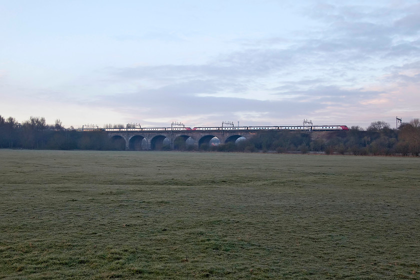 Class 350, LN 06.24 London Euston-Crewe (2U23) & class 221s, VT 05.38 Preston-London Euston (1A04), Haversham SP818425 
 London Northwestern meets Virgin on Haversham Viaduct. The 350 heads north with the 06.24 London Euston to Crewe whist the class 221s are into the last half hour of their early morning journey from Preston to Euston. I can't quite get my head round why an 8 coach diesel is utilised running all the way under the wires down the West Coast Mainline? I am sure that the timetablers at Virgin and Network Rail have their reasons but it does not seem to be the best use of available resources? 
 Keywords: Class 350 2U23 class 221s 1A04 Haversham