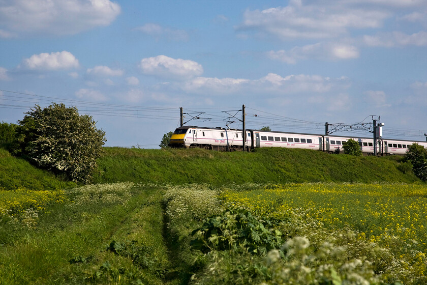 91130, GR 16.03 London King's Cross-Leeds (1D21), Yaxley TL194921 
 91130 approaches Peterborough from the south passing Yaxley leading the 1D21 16.03 London King's Cross to Leeds East Coast service. 
 Keywords: 91130 GR 16.03 London King's Cross-Leeds (1D21), Yaxley TL194921 East Coast InterCity 225