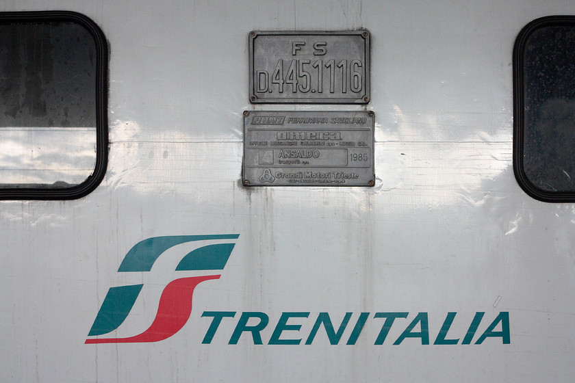 Nameplate & buildplate, 445.1116, 17.55 Florence SMN-Borgo SL (11993), Florence SMN station 
 The numberplate and buildplate of 445.1116 waiting at Florence SNM station with the 17.55 service to Borgo San Lorenz. Built by Fiat in 1985, this is one of the third series of these supercharged diesel locomotives that have been modified for push-pull operation. 
 Keywords: Nameplate & buildplate, 445.1116, 17.55 Florence SMN-Borgo SL (11993), Florence SMN station