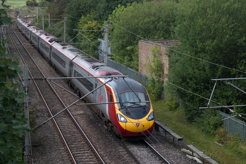 390126, VT 13.50 Birmingham New Street-London-Euston-(1B52, 3L), Dodford Lane Bridge SP623607 
 390126 'Virgin Enterprise' forms the 13.50 Birmingham New Street to Euston past Dodford Lane bridge just north of Weedon. Line speed is relatively low here due to numerous reverse curves causing the Pendolino and Voyager tilting systems to work overtime! 
 Keywords: 390126 1B52 Dodford Lane Bridge SP623607