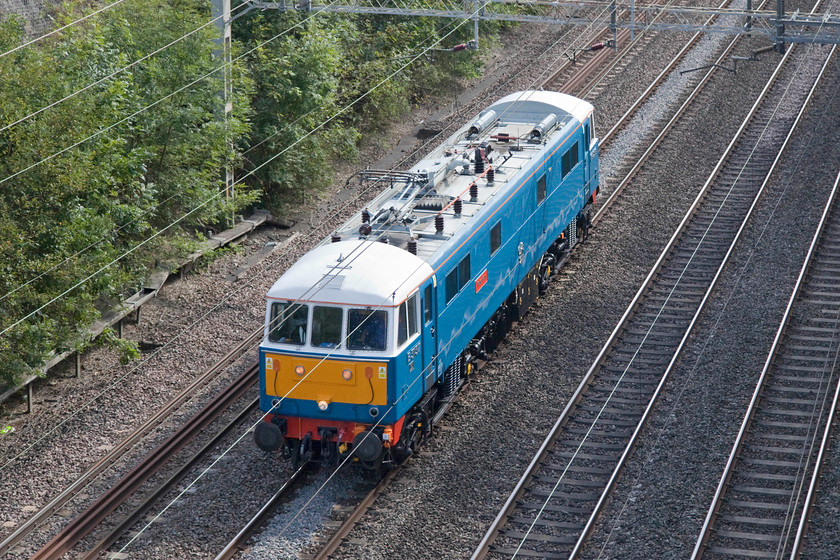 86259, 12.23 London Euston-Rugby CS (0Z88), Roade cutting 
 Personal experience has made me cautious when going out to photograph this 0Z88 light engine move. It is always timetabled to take the Weedon loop as the final part of its journey from Euston to Rugby carriage sidings. However, it often does not follow its booked route taking the Northampton route instead. I was half tempted to nip out and see this train near to Blisworth, if I had I would have been disappointed on this day as it did, indeed, go via Northampton. Here, 86259 'Peter Pan/Les Ross' passes through Roade Cutting on the down slow line. 
 Keywords: 86259 12.23 London Euston-Rugby CS 0Z88 Roade cutting