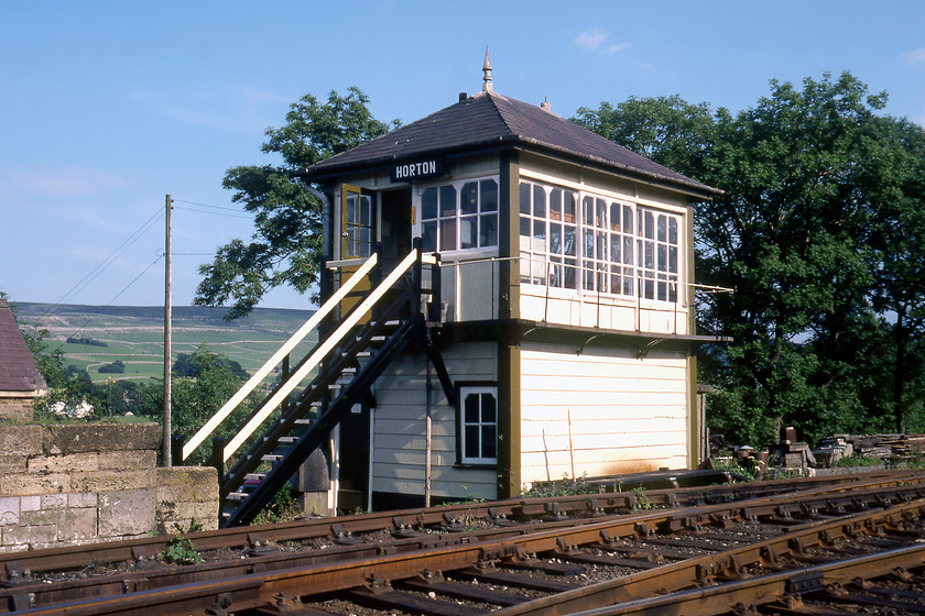 Horton Signal Box (MR, 1875) 
 In happier times Horton signal box stands in the afternoon sunshine looking smart and well maintained. It was a Midland Type 2b design from 1875 and located on the up side of the line a short distance off the southern end of Horton in Ribblesdale station. Note the remnants of the former cattle dock to the left of the steps. After falling into disuse but still containing its frame and leavers it was damaged by fire in April 1991 and demolished soon afterwards. This now leaves a long block section between Settle Junction and Blea Moor. 
 Keywords: Horton Signal Box