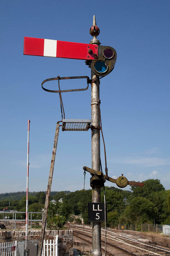 Up starter, Lostwithiel station 
 Against a brilliant mid-summer's day sky, the up starter signal at Lostwithiel (LL5) sits proudly waiting to be pulled off in order to allow the next train to pass eastwards. This starter is at the end of Lostwithiel station platform with the level crossing immediately beyond. 
 Keywords: Up starter signal Lostwithiel station