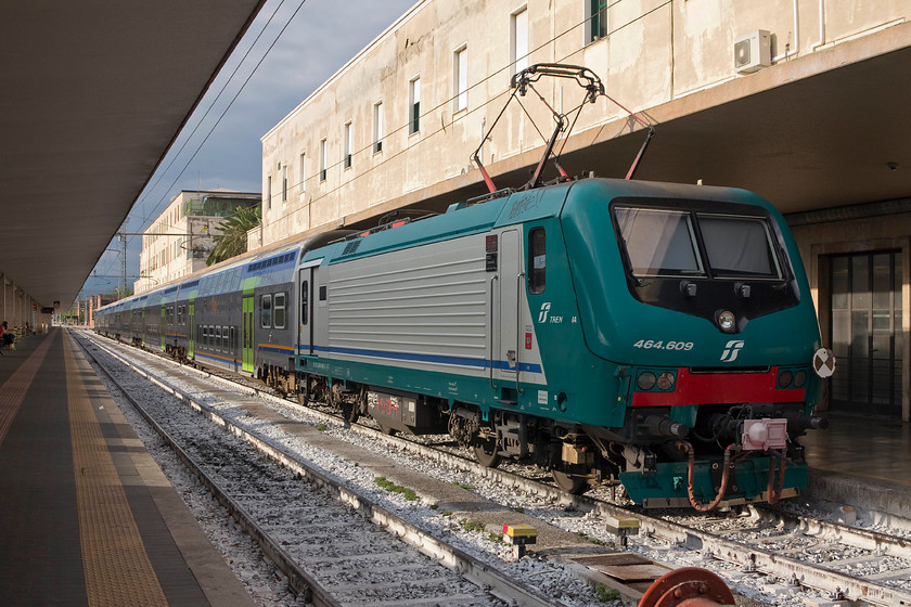 464.609, 18.35 Florence SMN-Arezzo (11673), Florence SMN station 
 In a final hurrah of evening sun, 464.609 waits to propel the 18.35 to Arezzo from Florence SNM station. I really enjoyed my short time around Florence looking to see what their railways had to offer, it was nice to get this sun-blessed shot as a final one! 
 Keywords: 464.609 18.35 Florence SMN-Arezzo 11673 Florence SMN station