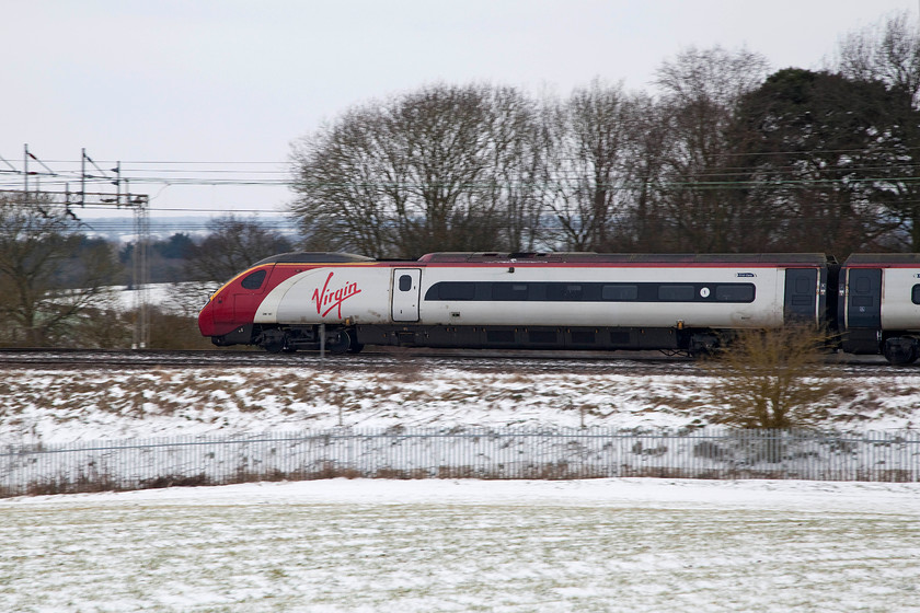 390107, VT 10.58 Preston-London Euston (1A16, 16L), between Roade & Ashton 
 390107 'Independence Day Resurgence' passes through the snowy Northamptonshire countryside working the 10.58 Preston to London Euston. By now, I had been standing in this cold field for sometime and I was anxious to make the short walk home! 
 Keywords: 390107 1A16 between Roade & Ashton