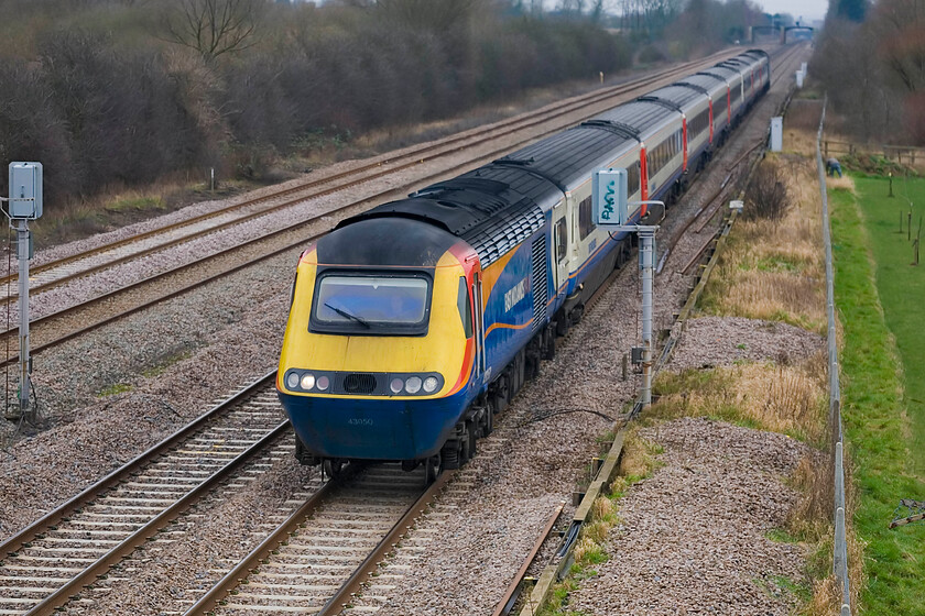 43050, EM 12.15 London St. Pancras-Nottingham, Lower Farm Road, Bromham TL028518 
 The 12.15 St. Pancras to Nottingham HST working accelerates away from Bedford passing near the village of Bromham lead by power car 43050. This power car dates from the summer of 1977 when it was introduced on the Western Region as part of set 253025. With the announcement that the GWML will be electrified as far as Bristol and Swansea the MML will remain the only trunk line radiating from London not under the wires; but for how long I wonder? 
 Keywords: 43050, EM 12.15 London St. Pancras-Nottingham, Lower Farm Road, Bromham TL028518