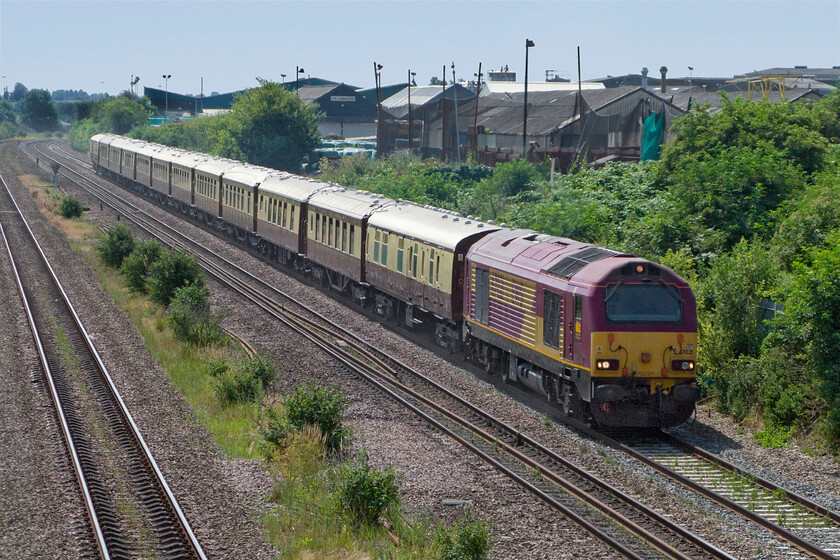 67021, 08.45 London Victoria-Chesterfield VSOE charter (for Chatsworth House) (1E02), Finedon Road industrial estate SP900702 
 Composed of a rake of former Pullman stock and some painted to resemble the older coaches the 08.45 Victoria to Chesterfield VSOE charter leaves Wellingborough past the town's delightful Finedon Road industrial estate. After a luxurious train journey the passengers, on arrival at Chesterfield, transferred to a fleet of coaches for onward travel to Chatsworth House. The train is led by 67021 which looks a little out of place leading this train in its EWS livery. 
 Keywords: 67021 08.45 London Victoria-Chesterfield VSOE charter Chatsworth House 1E02 Finedon Road industrial estate SP900702