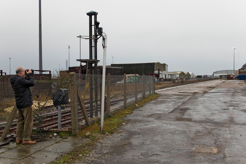 Andy, Newhaven Marine station 
 This was as far as we were permitted to go on to the old platforms of Newhaven Marine station. Since my last visit the station buildings have been demolished and the signal arm on the post to the left has also been removed. With the closure of the signal box and the adjacent level crossing the track past the old station is not going to be removed. Indeed, it is to be extended and will see future use carrying freight into the harbour complex down in the distance. 
 Keywords: Andy Newhaven Marine station