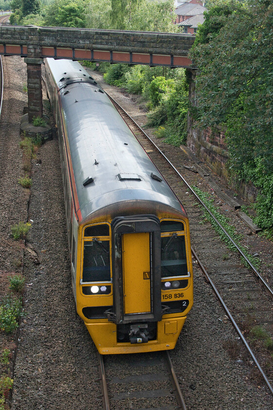 158836, AW 15.38 Holyhead-Birmingham International (1I26, 3L), Bonewaldesthorne's Tower Chester city wall 
 Taken from Chester's city wall 158836 approaches from the west with the 15.38 Holyhead to Birmingham International. At this location, the railway cuts through the city walls in two places with Bonewaldesthorne's Tower just out of sight to the right. 
 Keywords: 158836 15.38 Holyhead-Birmingham International 1I26 Bonewaldesthorne's Tower Chester city wall Transport for Wales