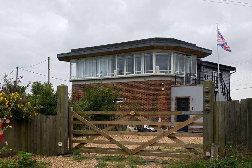 Former Murrow West signal box (LNER, 1950) 
 For such a small and remote village deep in the Fens between Peterborough and Wisbech Murrow has a fascinating railway history. There were once two railways operated by different companies, two stations and a rare flat crossing. The GN & GE line ran between March and Spalding once being a busy freight route with a local passenger service also offered an alternative route for diverted express services, particularly during the summer months. The single track M & GN line crossed the GN & GE to the west of the village with a station located on the latter's line of the same name. Murrow East was located more conveniently for the village but was the first to close. This British Railways built (to an LNER design) box opened in 1950 at the site of the flat crossing replacing a much earlier box that was destroyed in an accident on the crossing. I last visited the box back in 1981 when it was still in use see... https://www.ontheupfast.com/p/21936chg/30046908470/murrow-west-signal-box-lner, today it is a much extended private house as seen here. 
 Keywords: Former Murrow West signal box LNER 1950