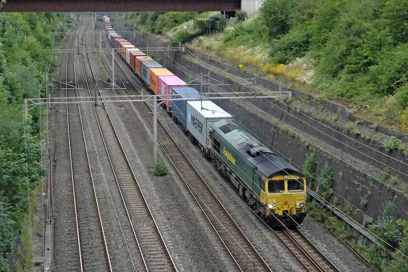 66540, 11.48 Lawley Street-London Gateway (4L46, RT), Roade cutting 
 Working noticeably slower than the previous electric hauled service (4L48) the 4L46 11.48 Lawley Street to London Gateway toils through Roade cutting. Freightliner's 66540 'Ruby' is leading the train; not one of my commonly photographed members of the class. 
 Keywords: 66540 11.48 Lawley Street-London Gateway 4L46 Roade cutting Ruby