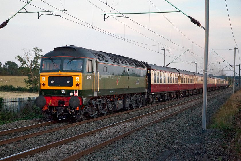 D1944, return leg of The Palatine, 17.44 Crewe-London Euston (1Z57), Milton Malsor 
 Dead in tow and swinging about on the rear, D1944 'Craftsman' is seen passing Milton Malsor just south of Northampton. The returning Palatine railtour left Crewe at 17.44 and will terminate at Euston in about an hour's time. The sun was just about spent by this time having all but disappeared behind some trees to my right, it's quite noticeable how much earlier it is getting dark by the last week in August. 
 Keywords: D1944 The Palatine 17.44 Crewe-London Euston 1Z57 Milton Malsor