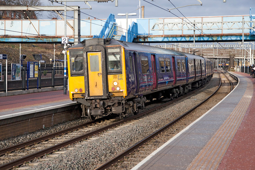 317345, GN 08.18 Peterborough-London King`s-Cross (2P37), Alexandra Palace station 
 In a brief burst of sunshine in an otherwise pretty dull morning, 317345 pauses at Alexandra Palace station forming the 08.18 Peterborough to London King's Cross. These four-car units were built by BREL at York between 1981 and 1987. They have operated on all the lines north of London at various times in their career reaching as far as Northampton, Bedford, Peterborough and Cambridge. Some have also worked out into Essex. 
 Keywords: 317345 08.18 Peterborough-London King`s-Cross 2P37 Alexandra Palace station