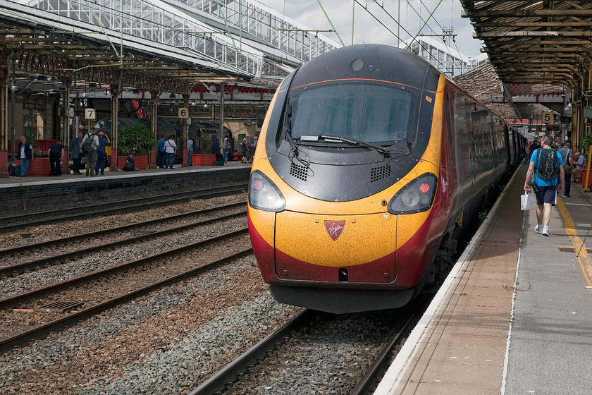 37706 & 37668, stabled & 390119, VT 12.40 London Euston-Manchester Piccadilly (1H67), Crewe station 
 The rear of 390119 waits at Crewe station having arrived with the 12.40 Euston to Manchester Piccadilly. This is one of the Manchester services that does not travel by the more usual and faster Stoke route. In the shadows over on the far left of the image 37706 and 37668 can be seen. 
 Keywords: 37706 37668 390119 12.40 London Euston-Manchester Piccadilly 1H67 Crewe station