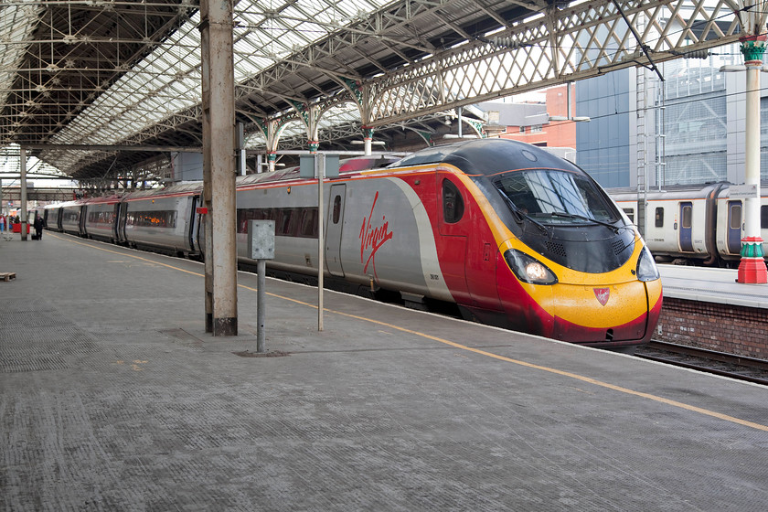 390001, VT 11.40 Glasgow Central-London Euston (1M12, 8L), Preston station 
 390001 'Virgin Pioneer' rolls into Preston station forming the 11.40 Glasgow to London Euston 1M12 working. These Pendolinos have been in service, at the time of writing, for 16 years and are still going strong being the backbone of the WCML services. This example is still in its original livery as applied back in 2002. 
 Keywords: 3900011M12 Preston station