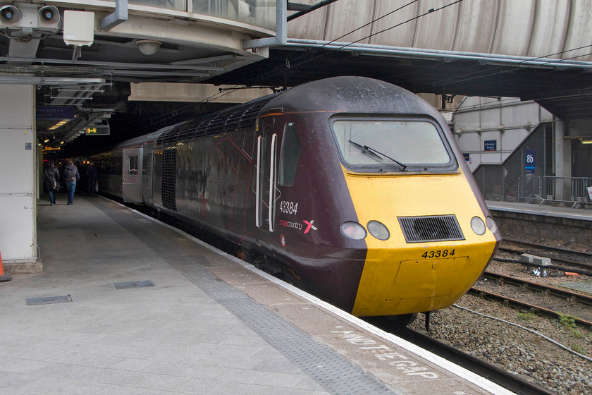 43384, XC 12.25 Plymouth-Glasgow Central (1S51), Birmingham New Street station 
 The tail end of the 1S51 12.25 Plymouth to Glasgow Central just emerges from the dark depths of Birmingham New Street station. Power car 43384 was a late production example being constructed to work on the NE/SW route that it is seen on here nearly thirty-five years later! Observe the simplicity of the hst's design in this image, particularly the single wiper arm that simple sweeps from one side to the other of the flat laminated screen. Compare that to today's multiple pantograph style wipers that are huge as they wipe the complicatedly shaped and aerodynamic screens. 
 Keywords: 43384 12.25 Plymouth-Glasgow Central 1S51 Birmingham New Street station CrossCountry hst