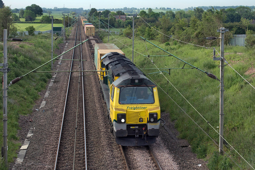 70007, 02.57 Felixstowe North-Garston (4M45), Milton Malsor SP738560 
 I took this photograph deliberately from this rather head-on angle for a reason. I wanted to emphasise the unusual dimensions of class 70, in this case, 70007. It is noticeable how narrow the midriff of class 70's design is, meaning the engines themselves must be very narrow. That and the rather bulbous cabs do not make this class of locomotive the most attractive on the network! The 4M45 02.57 Felixstowe North to Garston Freightliner passes Milton Malsor just south of Northampton. 
 Keywords: 70007 02.57 Felixstowe North-Garston 4M45 Milton Malsor SP738560