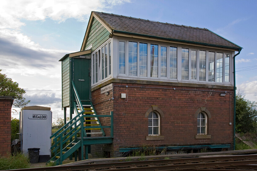 Brampton Fell signal box (NE, 1918) 
 Brampton Fell signal box is located at a delightfully rural spot where the B6413 road crosses the Carlisle to Newcastle line at fifty miles and ten chains from the latter. The 1918 North Eastern Railway box contains its original twenty lever McKenzie & Holland frame only which of three are in use today. There used to be an up and a down refuge siding but these fell out of use and were removed in the early 1970s. Whilst the personal needs of signalmen is vital the Portaloo seen here does spoil the aesthetics of the box somewhat! 
 Keywords: Brampton Fell signal box North Eastern Railway