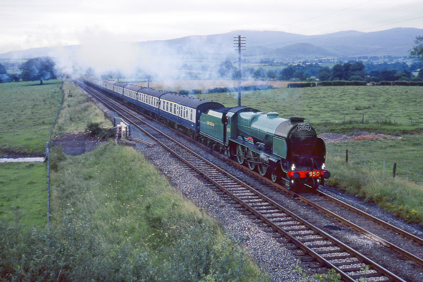 850, outward leg of Cumbrian Mountain Express, Carlisle-Skipton, Keld Farm 
 Having taken over the train at Carlisle Maunsell 4-6-0 850 'Lord nelson' gets into its stride as it passes Keld Farm just north of Appleby. It is a little incongruous to see a Southern Railway locomotive on the S & C but steam on the mainline then was quite a treat so anything went! It is leading the BR organised and promoted Cumbrian Mountain Express that proved to be popular with both passengers and lineside gricers alike and has proved an enduring train with them still running today but to a slightly different format. Notice the two round hills in the background of Knock and Dufton Pike with the bulk of Cross Fell (ex D5/44005) looming above them.

There is an audio recording of this event on my youtube channel, see...https://youtu.be/7Pdd4TRvBpk 
 Keywords: 30850 outward leg of Cumbrian Mountain Express Carlisle-Skipton Keld Farm 850 Lord nelson Maunsell