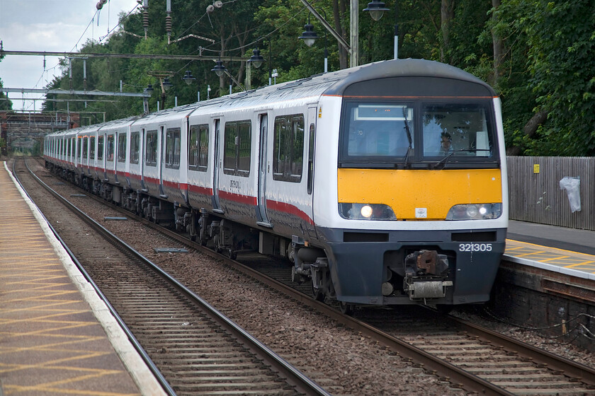 321305, GA 13.35 Colchester Town-London Liverpool Street (2F45, 3E), Ingatestone station 
 321305 leads another 'Dusty Bin' classmate through Ingatestone station as the 13.35 Colchester Town to Liverpool Street Greater Anglia service. These BREL (York) built units are now well over thirty years old and have been in continuous use on this line since their introduction replacing many classes of slam-door stock. They have been supremely reliable over the years but they are presently being withdrawn and scrapped due to modern stock, built abroad off course, replacing them. 
 Keywords: 321305 13.35 Colchester Town-London Liverpool Street 2F45 Ingatestone station Dusty Bin Greater Anglia