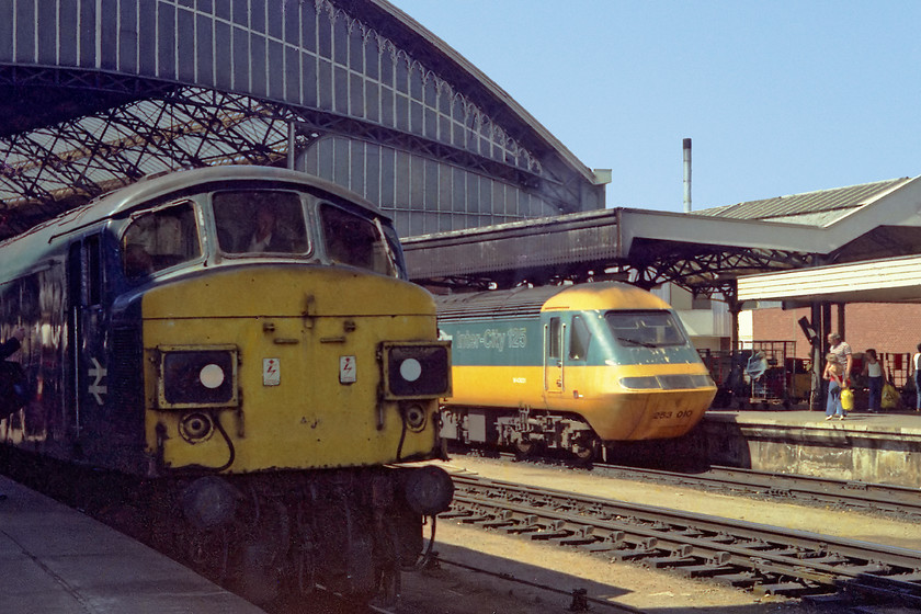 45024 & 253010, unidentified up workings, Bristol TM station 
 I love this shot, the new and modern HST sits in the bright sun just outside of Bristol Temple Meads' impressive train shed ready for a Paddington service. This puts the relatively old split-box 45 in the shade (literally!) The HST power car is 43021, which stayed on the Western Region all of its life until 2018 when it moved to Scotland to form part of their short sets. Steam heat 45024 had a less blessed life being withdrawn 3 years after this picture was taken and broken up at Swindon during 1983.

PS This HST power car was the one that caught fire crossing the Tay Bridge on 28.02.25, an event that will have almost certainly precepitated its demise.