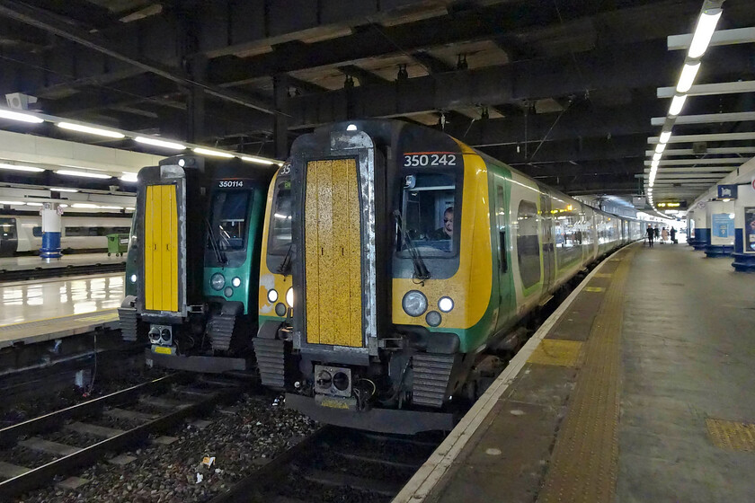 350242, LN 13.23 London Euston-Birmingham New Street & 350114, LN 13.24 London Euston-Tring (2T39, RT), London Euston station 
 Inside the gloom of Euston station, despite the sunny weather outside, a pair of London Northwestern's finest await their next duties. To the left 350114 will work the all-stations stopper service to Tring leaving at 13.24. To the right, 350242 will leave just a minute earlier with the 13.23 to Birmingham New Street. My wife and I travelled on the Birmingham service as far as Northampton. 
 Keywords: 350242 13.23 London Euston-Birmingham New Street 350114 13.24 London Euston-Tring 2T39 London Euston station London Northwestern Desiro