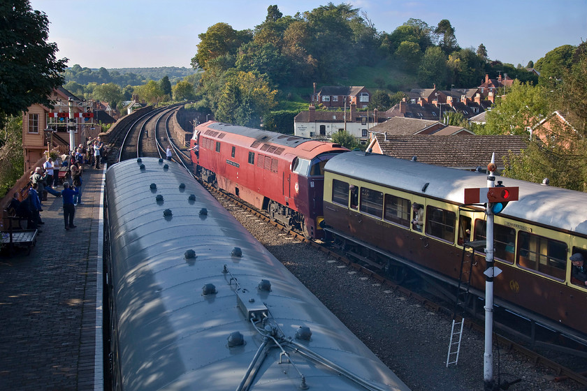 D1062, 15.23 Kidderminster-Bridgnorth, Bewdley station 
 In beautiful late afternoon lighting that only goes to reinforce my assertion that this is quite the best time of year to take railway photographs, D1062 'Western Courier' gets away from Bewdley station leading the 15.23 Kidderminster to Bridgnorth with the crew exchanging the token with the signalman. Whilst the enthusiasts aim their cameras at the Western a Class 108 DMU waits empty in the shade on platform one to proceed the short distance up the line following the Bridgnorth service as the first part of a run-round manoeuvre. 
 Keywords: D1062 15.23 Kidderminster-Bridgnorth Bewdley station Class 108 DMU Western Courier