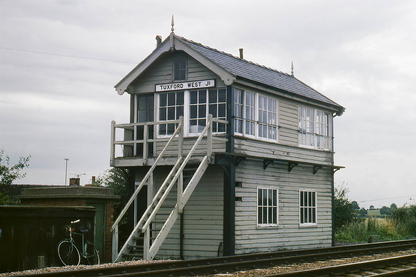 Tuxford West Junction signal box (GC, after 1907) 
 The delightful Tuxford West Junction signal box is seen under cloudy skies, and after such a promising start to the day! With the signalman's vintage bike leaning outside the Great Central 1907 box that is located on the line that ran between Lincoln and Clipstone Junction. At the time this picture was taken this line crossed the ECML a short distance to the right with a spur joining to the ECML. In its latter years, the line remained as a freight only route to the former High Marnham power station until its closure in 2003. Despite this, the line is still in use as the Network Rail's High Marnham test track. However, this signal box has long been demolished with the whole test track unsignalled from its start at Thoresby Colliery Junction. 
 Keywords: Tuxford West Junction signal box