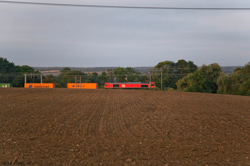 66128, 02.35 London Gateway-Trafford Park (4M83, 23L), between Roade & Ashton 
 Having left home early to see the sleeper I had got this location when it passed running some fifteen minutes early dashing my efforts! However, I did capture the 4M83 02.35 London Gateway to Trafford Park working northwards. This is not a freight that I have ever managed to photograph as it normally passes Roade in the dark but today it was running extremely late. It is seen passing a recently min-tilled field between Roade and Ashton with DB's 66128 leading (with thanks to Mike for identifying the loco. for me from TOPS). 
 Keywords: 66128 02.35 London Gateway-Trafford Park 4M83 between Roade & Ashton DB