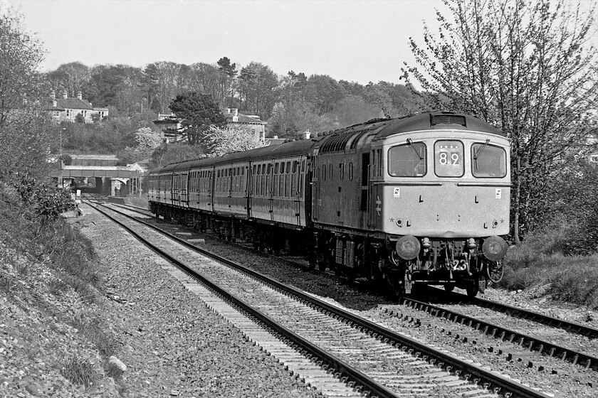 33023, unidentified Portsmouth Harbour-Bristol Temple Meads working, Bradford-on-Avon no. 1 crossing, ST822605 
 Using my telephoto lens attached to my Pentax MESuper brings a slightly different view but taken from the same position as the last photograph. In this view, the station, the footbridge, the Frome and Trowbridge Road bridges and Greenland tunnel have all been brought much more into view and appear much closer together than is the reality. 33023 accelerates away from its stop at Bradford-on-Avon working a Portsmouth Harbour to Bristol Temple Meads service that may well have been extended on to Cardiff Central. 
 Keywords: 33023 Portsmouth Harbour-Bristol Temple Meads working Bradford-on-Avon no. 1 crossing ST822605 Crompton