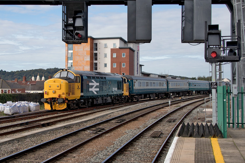 37418, 09.51 Rhymney-Cardiff Canton sidings ECS (5F10), Cardiff Central station 
 37418 brings up the rear of the 09.51 Rhymney to Cardiff Canton empty coaching stock move as it leads Cardiff Central station. This was an additional service run following the failure of a Pacer earlier in the morning. Out of sight on the front of the train is split headcode 37025. Whilst the stock is mainly Mk. II air-conditioned stock in classic BR blue and grey the second in the consist is in ATW's turquoise and white. 
 Keywords: 37418 09.51 Rhymney-Cardiff Canton sidings ECS 5F10 Cardiff Central station