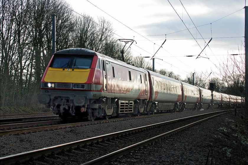 91129, GR 13.00 London King`s Cross-Edinburgh (1S18, RT), Gill`s Crossing 
 Catching the low afternoon sunshine partially obscured by some troublesome cloud, 91129 heads north with the 13.00 King's Cross to Edinburgh Waverley 1S18 express. Despite the well-documented reliability problems that have come in phases throughout their thirty-year life, the class 91s are strong, powerful and fast locomotives that have provided good service on the ECML. I am sure that there is life still left in them and the superb Mk. IV stock and that another operator will take them on. 
 Keywords: 91129 13.00 London King`s Cross-Edinburgh 1S18 Gill`s Crossing Offord Cluny LNER