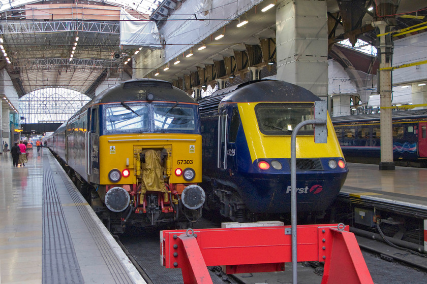 57303, GW 21.45-Penzance-London Paddington Sleeper (1A40) & 43025, GW 8.00 London Paddington-Bath Spa (1U05), London Paddington station 
 First Great Western is having to hire in locomotives for the Night Riviera services due to their own fleet prooving to be unreliable. At the stops of Paddington's platform one, DRS' 57303 rests having worked the 21.45 Sleeper from Penzance. Next to it 43025 will soon power at the rear of the 08.00 to Bath Spa terminating due to electrification preparation works between there and Bristol. 43025 wears nameplates that must have one of the longest names, 'IRO The Institute of Railway Operators : 2000-2010 Ten Years Promoting Operational Excellence'. 
 Keywords: 57303 21.45 Penzance-London Paddington Sleeper 1A40 43025 08.00 London Paddington-Bath Spa 1U05 London Paddington station First Great Western Direct Rail Services DRS IRO The Institute of Railway Operators : 2000-2010 Ten Years Promoting Operational Excellence