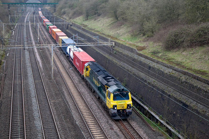 70003, 03.26 Garston-London Gateway (4L52), Roade Cutting 
 70003 was making a fair old racket as it climbed the 1:200 grade from Northampton that begins to level out only when the train reaches this location, Roade Cutting. It was heading the heavily laden 03.26 Garston to London Gateway Freightliner (4L52). These locomotives have gained quite a reputation for the noise that they make. Indeed, living close to the WCML as I do, a class 70 always grabs my attention over other motive power as it passes. 
 Keywords: 70003 03.26 Garston-London Gateway Freightliner 4L52 Roade Cutting