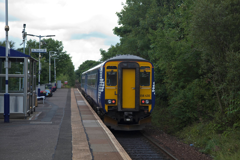 156430, SR 10.28 Kilmarnock-Glasgow Central (1A17, 1L), Kilmaurs station 
 156430 leaves the small station at Kilmaurs. This is the first station into its journey, the 10.28 Kilmarnock to Glasgow Central. Kilmaurs station was opened in May 1984 by BR. The original station was closed in 1966. 
 Keywords: 156430 1A17 Kilmaurs station