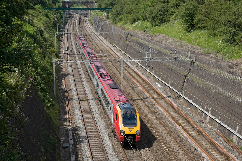 Class 221, VT 13.35 Chester-London Euston (1A40), Roade cutting 
 The 13.35 Chester to London Euston Virgin Voyager service passes through Roade cutting taken from the lofty heights of one of the two occupation bridges that span the magnificent structure completed in 1838 under the watchful eye of Robert Stephenson. 
 Keywords: Class 221 13.35 Chester-London Euston 1A40 Roade cutting Virgin Voyager