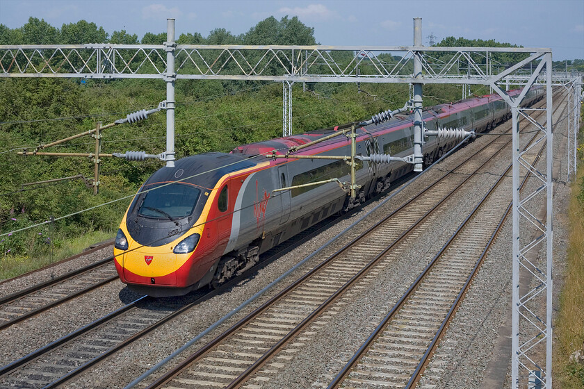 390129, VT 09.50 Birmingham New Street-London Euston (1B12), Bradwell SP831391 
 390129 'City of Stoke-on-Trent' passes the Milton Keynes housing area (as they are referred to) of Bradwell with the 09.50 Birmingham to Euston Virgin service. Despite the trees and lack of buildings, this, location is close to Milton Keynes station and centre such is the way that the new town has been designed. 
 Keywords: 390129 09.50 Birmingham New Street-London Euston 1B12 Bradwell SP831391 Virgin Pendolino City of Stoke-on-Trent