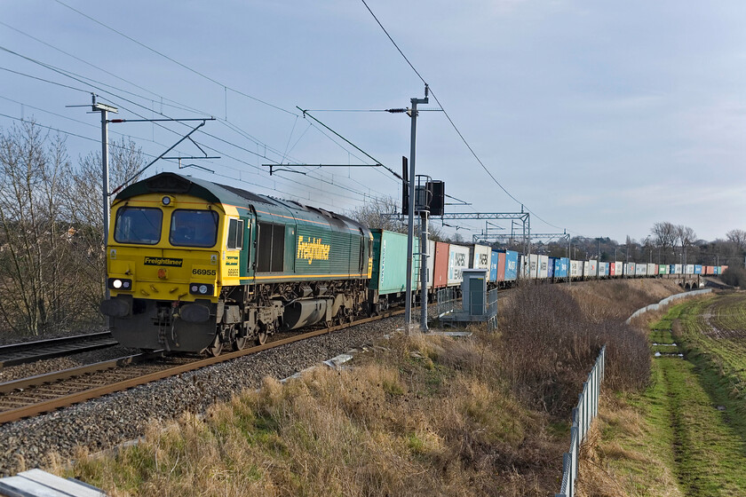 66955, Felixstowe North-Lawley Street (4M94), Wilson's Crossing 
 66955 leads a well-loaded 4M94 Felixstowe to Lawley Street Freightliner service away from Northampton. The train is seen passing Wilson's Crossing to the north of Northampton. 
 Keywords: 66955 Felixstowe North-Lawley Street Freightliner 4M94 Wilson's Crossing