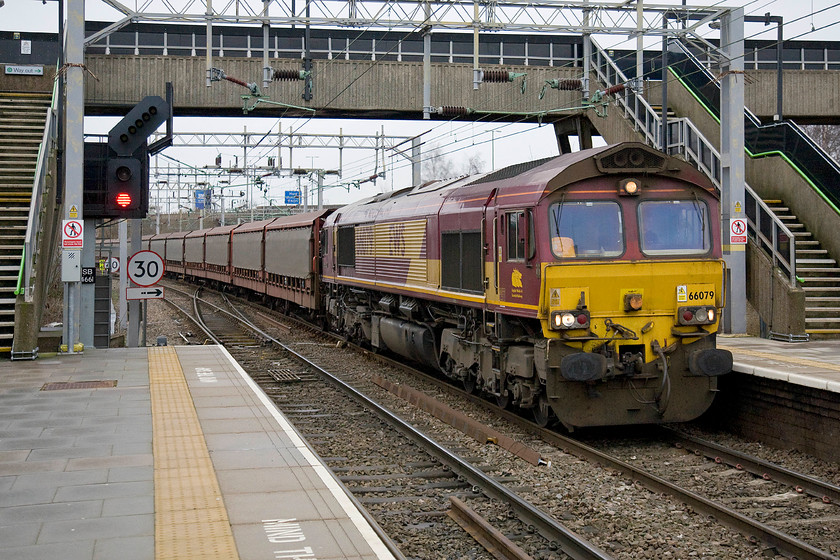 66079, 11.33 Halewood-Southampton Eastern Docks (6O42), Bescot Stadium station 
 Tens of thousands of pounds worth of Range Rovers for export pass through Bescot Stadium station behind EWS 66079 'James Nightall G.C.' leading the 11.33 Halewood to Southampton Docks. James Nightall was the fireman on the ammunition train that he saved, along with the driver Ben Gimbert, from explosion, bar one truck, just outside Soham in Cambridgeshire in 1944. Whilst Nightall died, his driver Ben Gimbert survived with terrible injuries. 
 Keywords: 66079, 11.33 Halewood-Southampton Eastern Docks (6O42), Bescot Stadium station