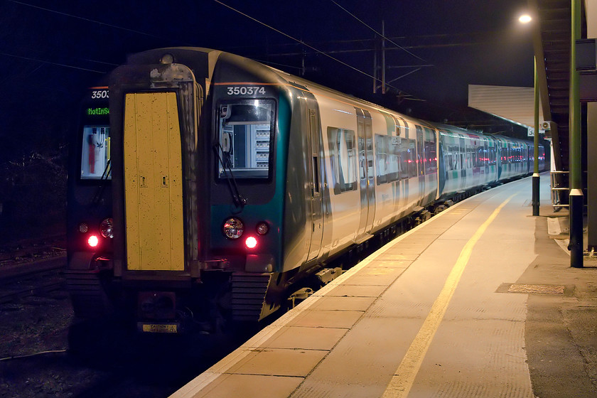 350374, LN 20.50 KIngsheath-Northampton ECS (5N44), Northampton station 
 350374 has been stabled at Northampton's platform three having been brought down the short distance from the Kingsheath depot as 5N44. With the reduction in area of the hi-viz yellow front end on the front of these units, they do not photograph particularly well at night with these huge areas of green darkness! 
 Keywords: 350374 20.50 KIngsheath-Northampton ECS 5N44 Northampton station